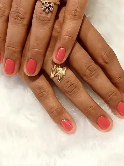 A simple gel polish can never go wrong. This is a beautiful, clean manicure in a lovely coral-pink shade, perfect for a fresh and polished look.