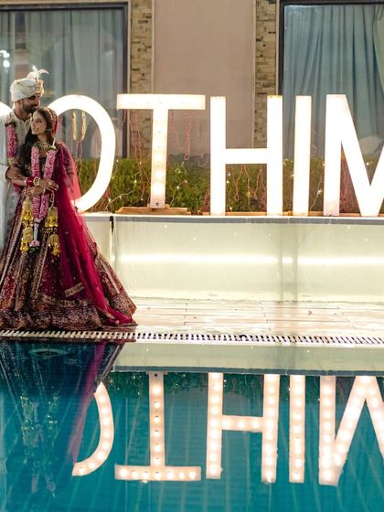 A poolside portrait with a creative flair. The reflection in the water adds a touch of magic to this unique wedding couple shot.