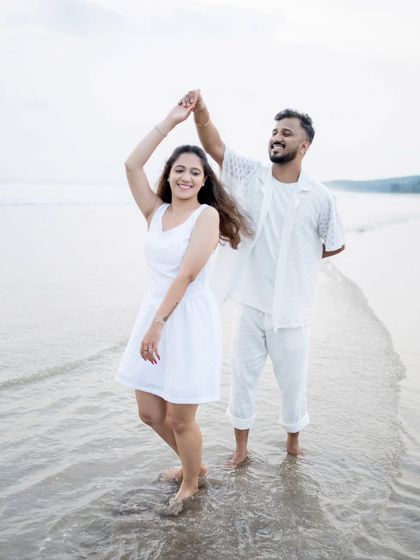 A happy, dancing moment in the shallow waters of the beach, full of life and joy.