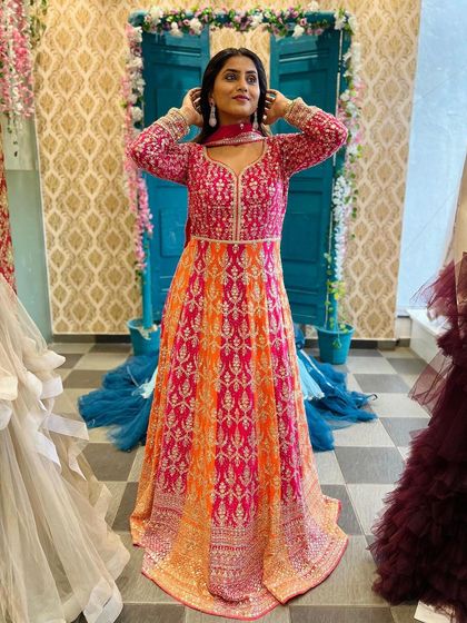 Feel pretty like the moon in this stunning pink and orange Anarkali style gown. The heavy embroidery on the yoke makes it a rich and festive outfit, perfect for a wedding or reception.