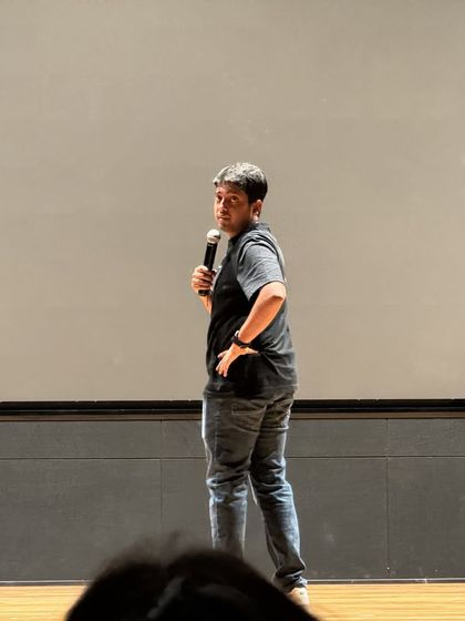 Aakash Gupta looking back at the audience, creating a moment of connection during his set.