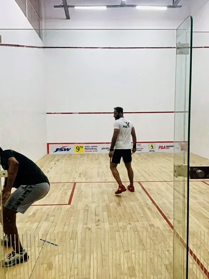 Players warming up on the court before a high-stakes match at the JSW Memorial Open.
