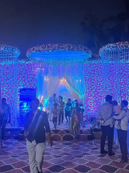 The same floral wall from the daytime setup, now completely transformed by night. I used dramatic blue uplighting to give the flowers a magical, otherworldly glow for the evening reception.