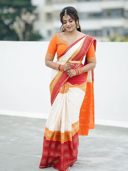 A full-length shot showing how the minimalist mehendi fits perfectly with her complete traditional look.