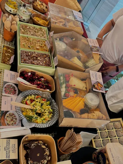 A top-down view of the delicious spread at my Chandigarh pop-up. The display includes fresh salads, grazing boxes, mithai, and chocolate almond rocks.
