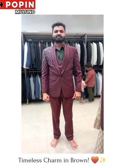 This client is wearing a brown three-piece suit with sequin detailing on the shoulder. It's a unique and stylish choice that adds a bit of sparkle to a formal look.