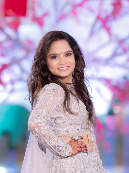 A beautiful portrait of the bride at her reception. Her smile is radiant, and the soft glam makeup enhances her happiness.