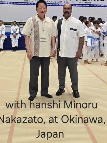 Standing with Hanshi Minoru Nakazato at a tournament in Okinawa, Japan. His guidance is invaluable in maintaining the high standards of Shorin-ryu Shorinkan in India.