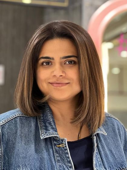 A happy client showing off her new brown bob with subtle highlights. The style is fresh, modern, and perfectly suits her.