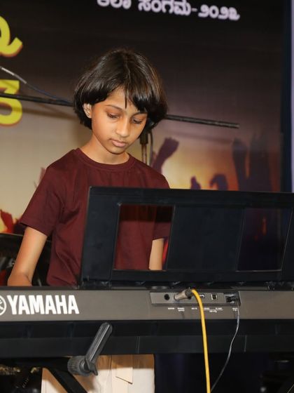 A student keyboardist focused on her part during the 'Vande Mataram' performance.