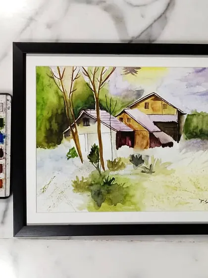A framed watercolor landscape of a rustic home in the snow. Watercolors are perfect for capturing the soft light and subtle color shifts of a winter scene.