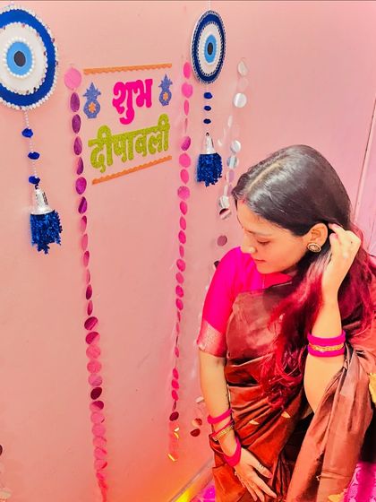 Another Diwali look, this time in a beautiful brown and pink silk saree. The evil eye wall hangings in the background are part of my festive home decor.