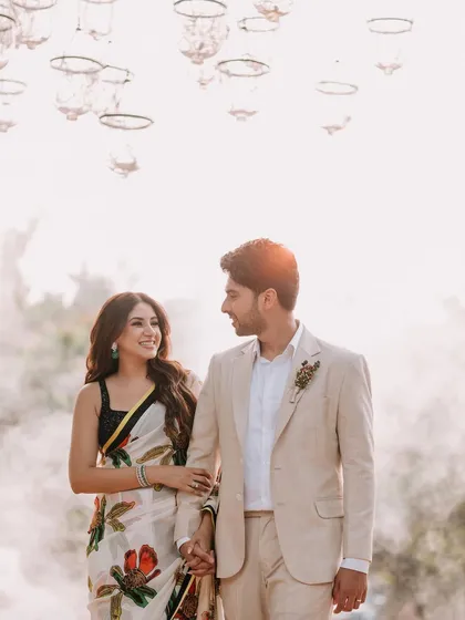 A dreamy, romantic portrait of a newly engaged couple. The soft smoke and warm sunlight create an ethereal atmosphere, perfectly framing their love.