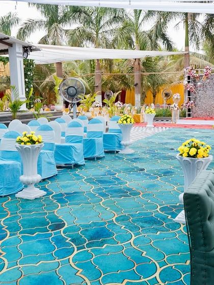 The seating arrangement for the blue-themed Haldi. The turquoise carpet and chair covers tie the whole look together, creating a cohesive and visually appealing space for guests.