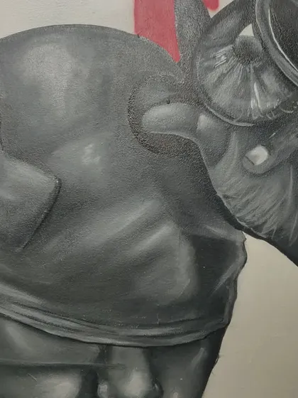 A close-up of the right side of the 'STATES OF MIND' mural, highlighting the hand holding a horn-like object.