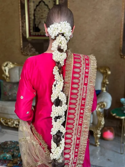 This angle shows the sheer length and beauty of the mogra braid, a testament to traditional Indian hairstyling.