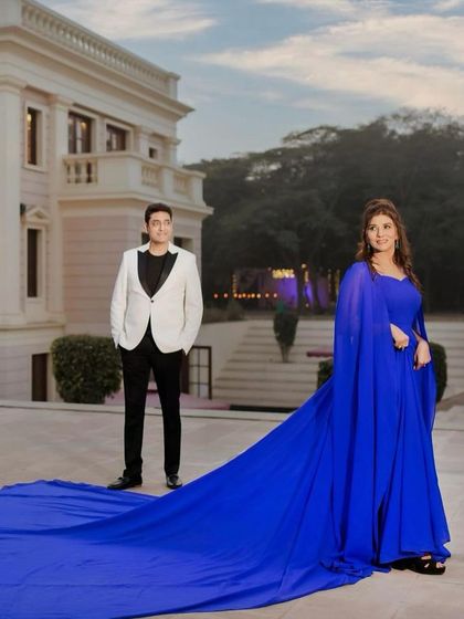 A majestic shot with a long, flowing gown. The makeup is glamorous and regal, making her look like a queen on her special anniversary.