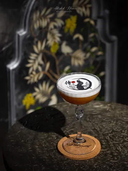 A specialty cocktail for Fairmont Jaipur, featuring custom foam art. This shot demonstrates my technique in beverage photography, using dramatic lighting to create a sophisticated mood and highlight the unique presentation of the drink.