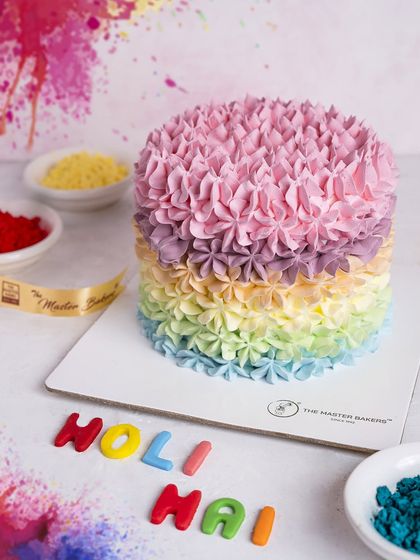 A more subtle take on a Holi cake, this design features beautiful pastel rainbow piping. The words "Holi Hai" in colorful fondant complete the festive look.