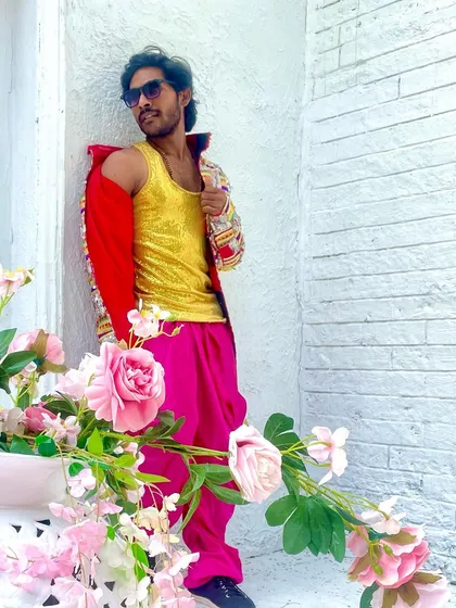 Another look from the song shoot. The bright colors and shiny fabrics are a key part of the performance style.