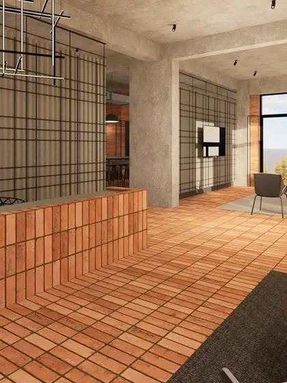 The reception area of the Incubation Centre at JIM Noida features a distinctive terracotta brick desk. The design follows the material palette of the larger campus, celebrating humble materials in an industrial aesthetic.