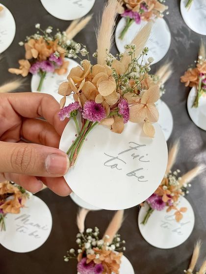 A close-up of one of the baby shower name tags. The combination of engraved acrylic and delicate florals creates a beautiful, modern, and feminine look.