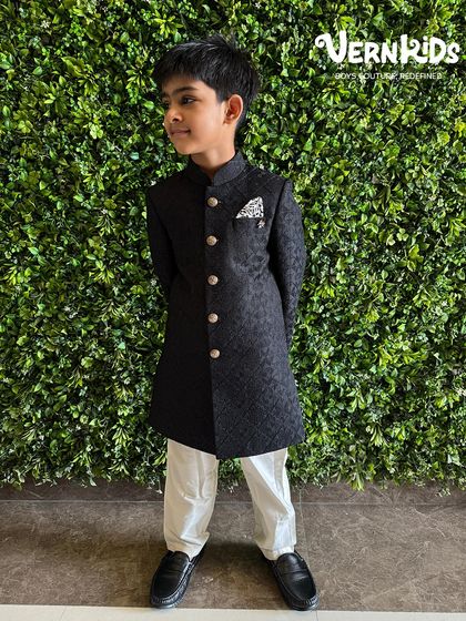 Main character energy in our classic black sherwani. This piece is all about sharp, tailored lines and a confident look, perfect for the little gentleman who loves to stand out at family weddings and receptions.