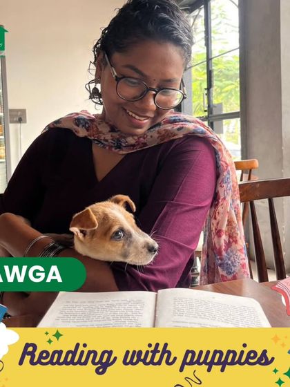 An event poster for our "Reading with puppies" session, showing a participant smiling while holding a pup and reading a book.
