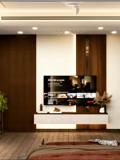 This bedroom TV unit combines dark wood paneling with a white floating console. The design is simple yet elegant, with recessed ceiling lights providing ample illumination for the space.