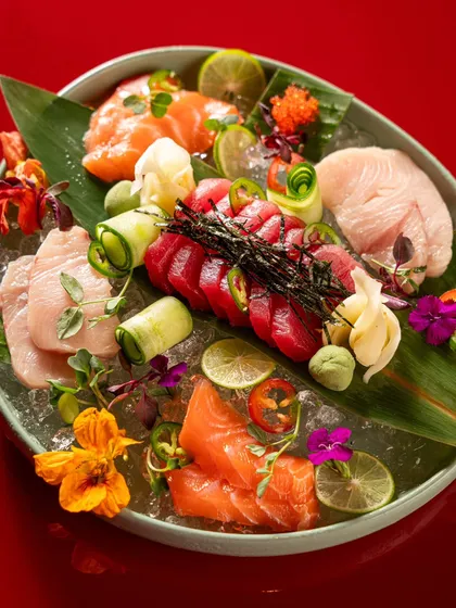 This shot demonstrates our expertise in high-end food styling and photography. We meticulously arranged this vibrant sashimi platter on a bed of ice with edible flowers to create a visually stunning image for a fine-dining Asian restaurant.