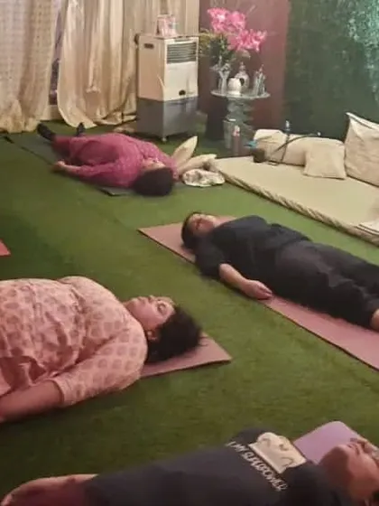Students in a state of deep relaxation during Yog Nidra, or yogic sleep. This guided meditation technique induces complete physical, mental, and emotional relaxation.