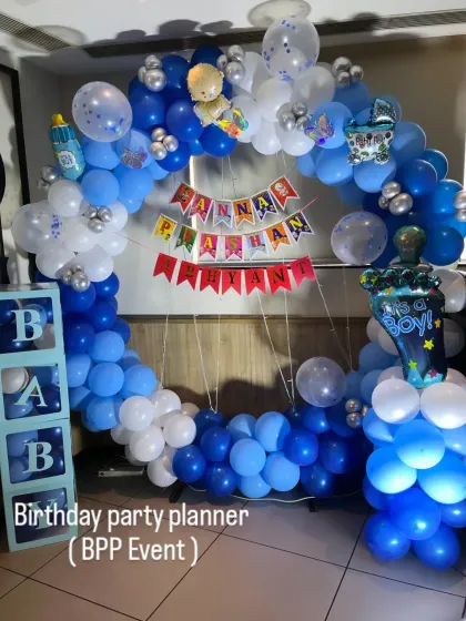 A decoration for an Annaprashan (first rice-eating ceremony). This setup features a blue and white balloon ring, 'BABY' blocks, and a custom banner.