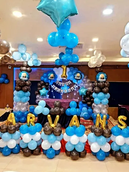 An elaborate Boss Baby setup for Aarvansh, with balloon pillars spelling out his name in front of the main stage.
