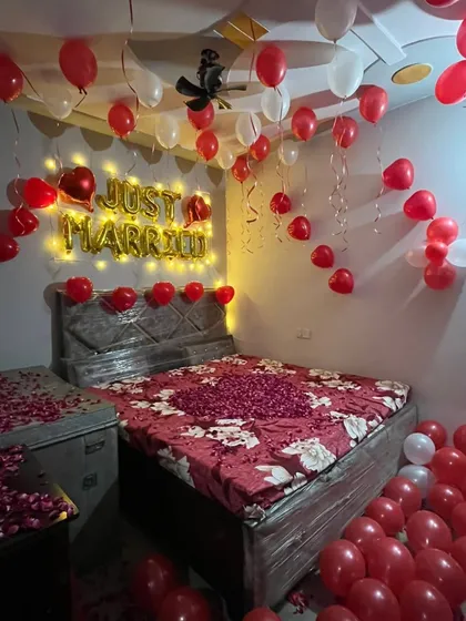 A detailed view of the bed and balloon arrangement for a first night surprise. I use a mix of regular and heart-shaped balloons to enhance the romantic theme.