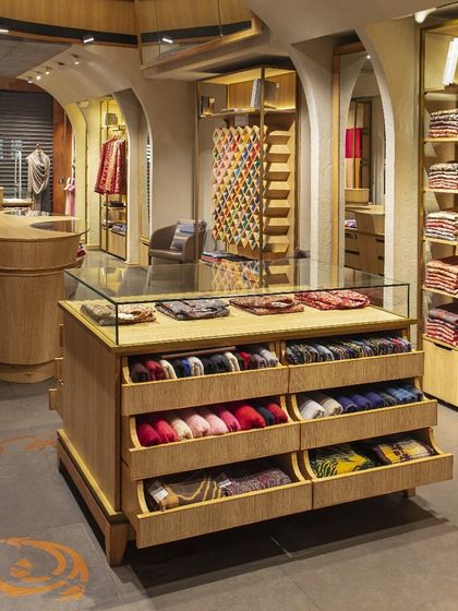 This image showcases the bespoke charm of the Ahujasons store, where every detail reflects artisanal mastery. The custom drawers and display cases are crafted with precision and soul, much like the handcrafted collection they hold.
