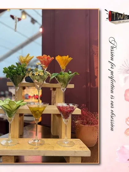 An artistic display of fresh garnishes, from herbs and flowers to sliced fruits, ready to be used in our handcrafted cocktails. We believe the garnish is the final touch of artistry.