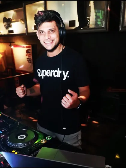 A smiling shot of me at the Hard Rock Cafe console, clearly enjoying the throwback music set.