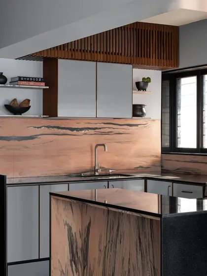 This kitchen features a stunning pink marble that I used for the backsplash and island cladding. The stone's natural, flowing pattern becomes the artwork in the room.