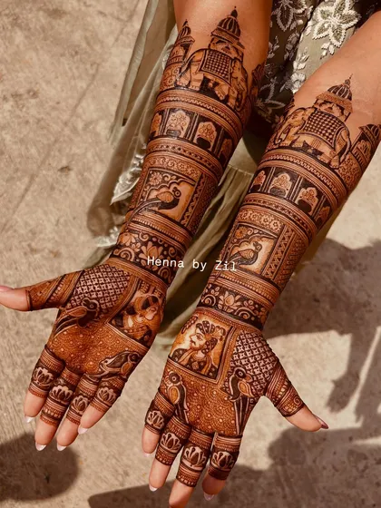 A truly royal design featuring story bands of peacocks and elephants. The intricate details and symmetrical patterns create a stunning effect that extends up the arms.