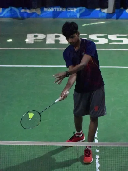 A player preparing for a service return, demonstrating the focus and ready stance we instill in all our athletes.