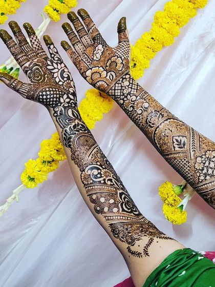 A lovely bridal henna design for Nadia, with a festive background of marigold flowers. The pattern is a mix of Indo-Arabic flow and detailed Indian fillers.