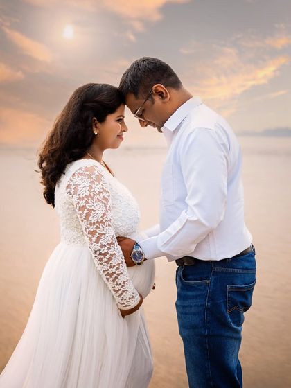 An intimate moment between a couple on the beach, with their heads together in quiet anticipation. The soft sunset light adds to the romance of this beautiful memory.