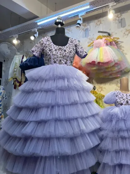 Here is a look at a mother-daughter twinning set on mannequins. The lavender gowns feature intricate hand embroidery on the bodice and a full, tiered tulle skirt.