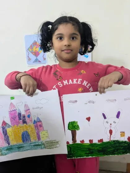 Double the art, double the fun! This young student is happy to present her colorful castle drawing and a lovely rabbit illustration, both filled with imagination.