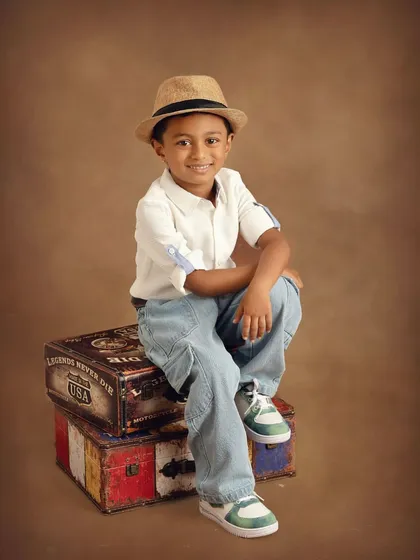 Capturing the sweet and playful spirit of kids' fashion is a special joy. This little gentleman's portrait shows how I mix stylish outfits with fun props to let his personality shine through.