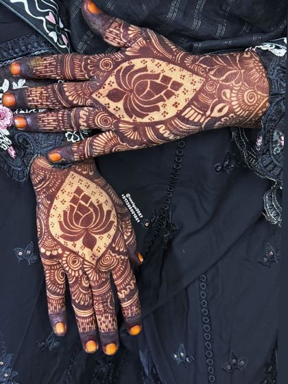 A beautiful, symmetrical view of the lotus designs on both palms. It's a very serene and spiritual motif.