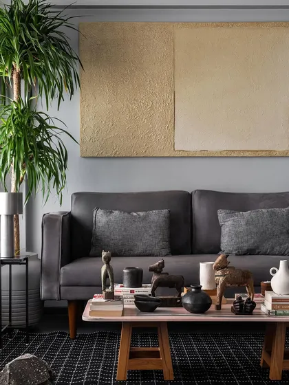 A custom grey sofa provides a comfortable anchor for this living room. I designed it with clean lines and plush cushions, paired with a low, rustic coffee table to create a relaxed yet sophisticated gathering space.