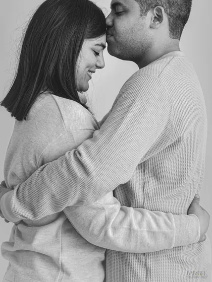 An intimate black and white portrait of a couple sharing a quiet, loving moment. This style of photography removes distractions and focuses purely on emotion and connection, resulting in a timeless piece of art.