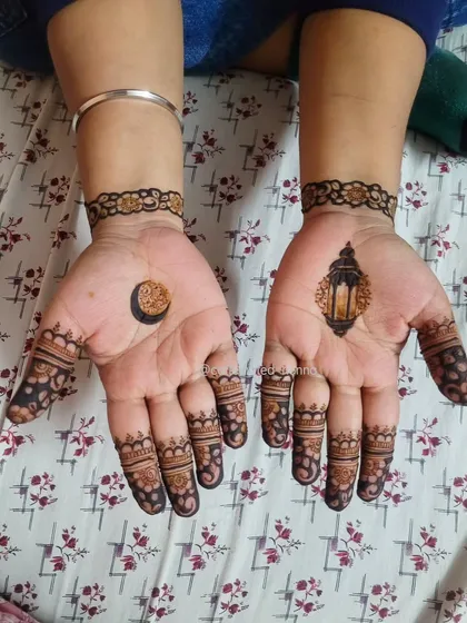 This minimal Chand Raat design features a crescent moon on one palm and a lantern on the other, with simple finger and wrist details. It's a modern take on festive symbols.