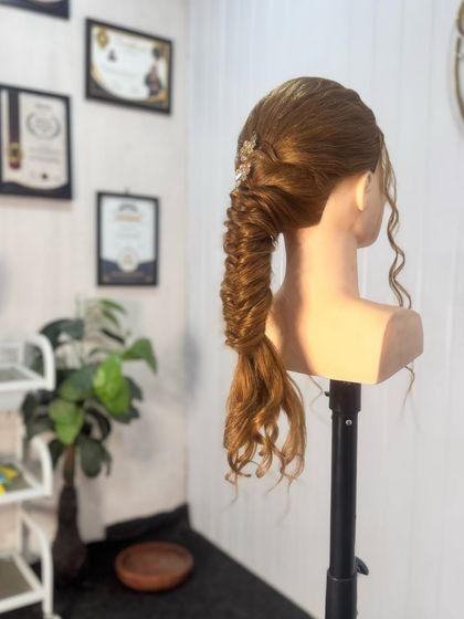 A beautiful and complex fishtail braid, a popular choice for pre-wedding events. My students learn various braiding techniques to offer a wide range of styles to their clients.